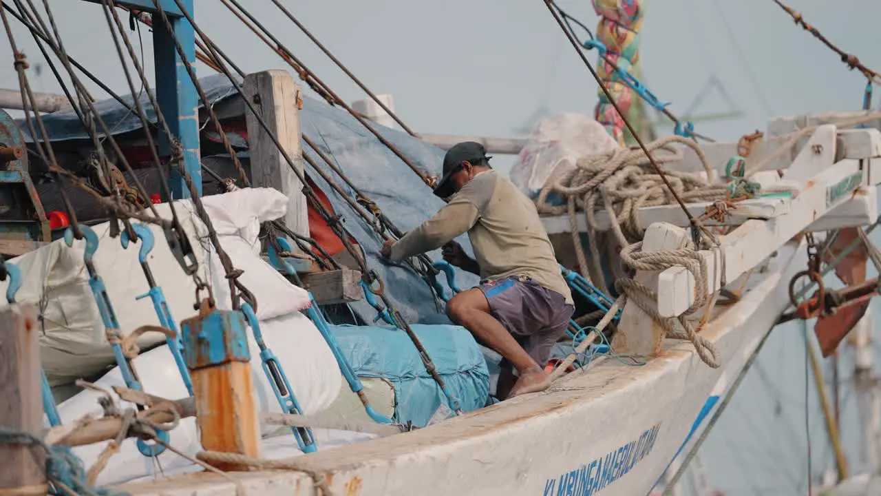 Mid Shot of Man Tightening Stuff on Boat