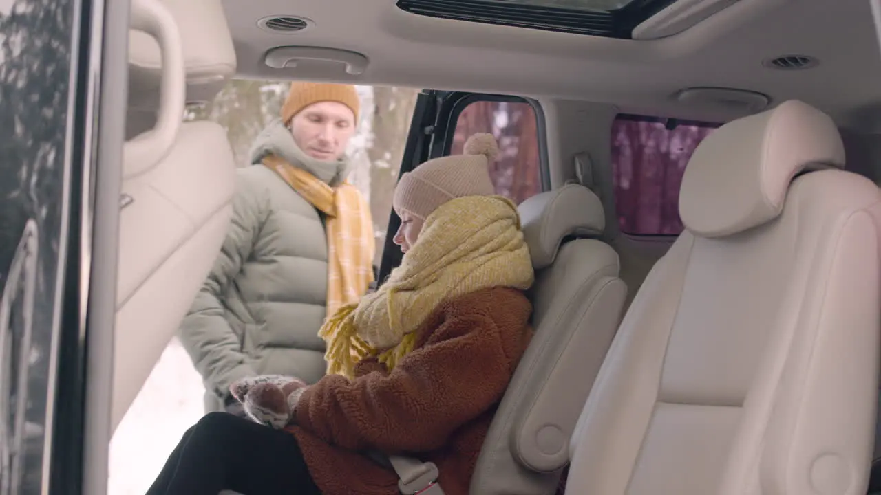 Side View Of A Girl Sitting In The Back Seat Of A Car 1