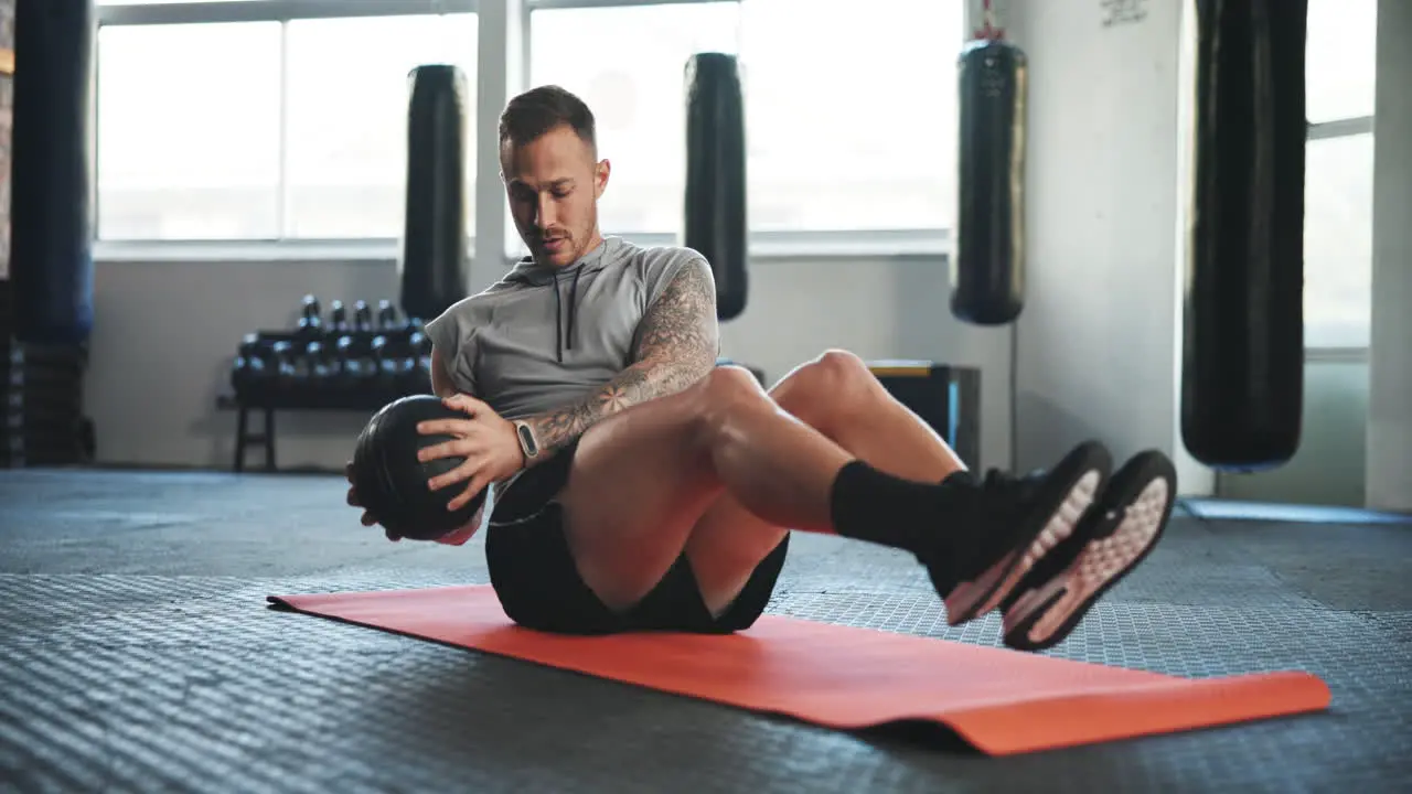 Fitness gym and man on floor with ball for core