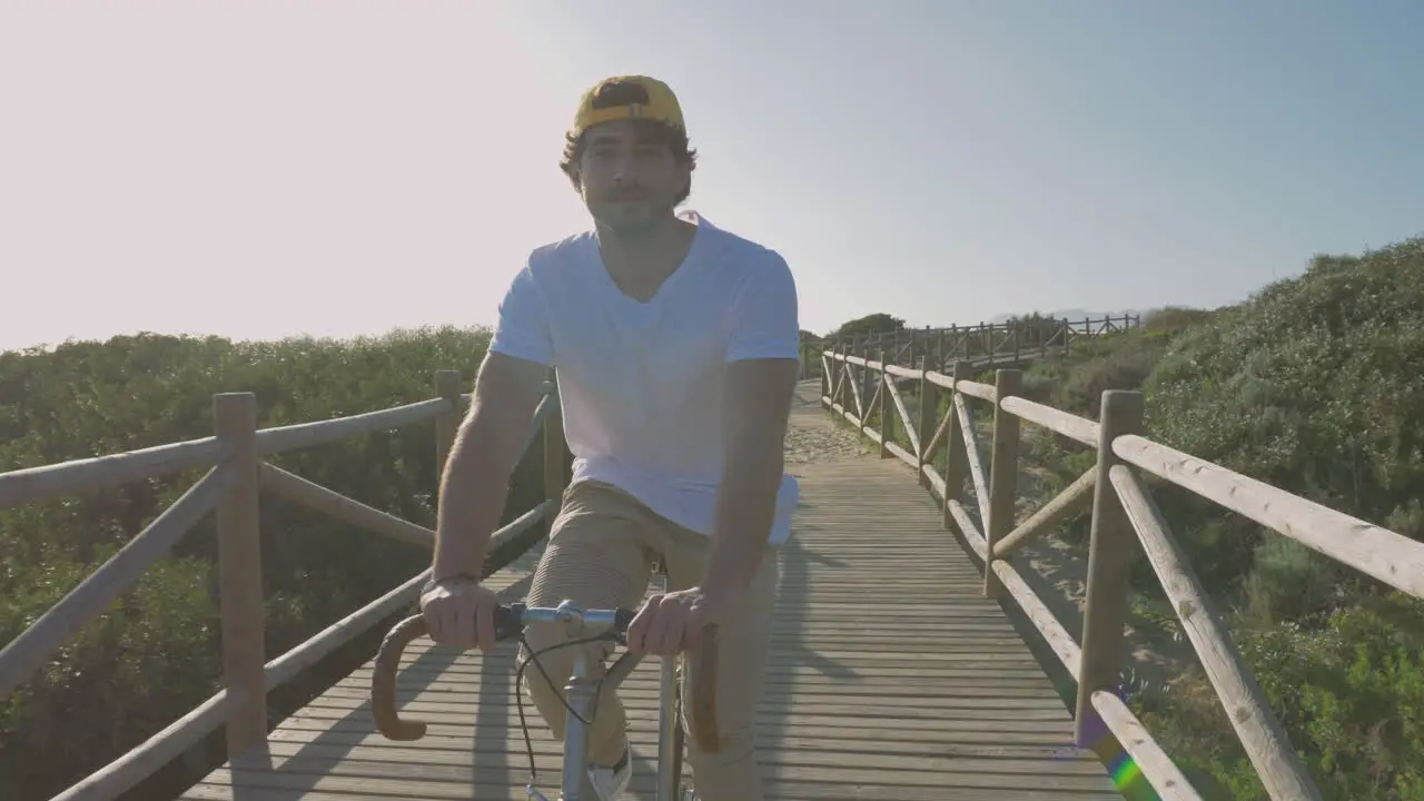 Male Cyclist On A Boardwalk Towards The Beach 2