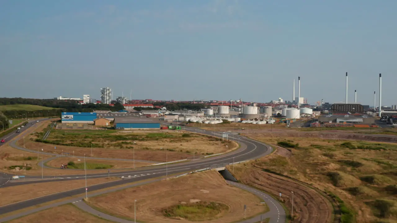 Aerial view of chimneys of petrochemical industries in Esbjerg Denmark seaport Drone view showing Esbjerg Tower under construction