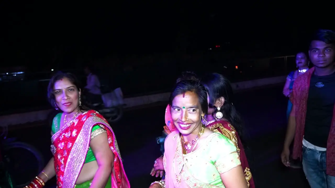 People dancing wildly on the street in the Indian wedding Baraat