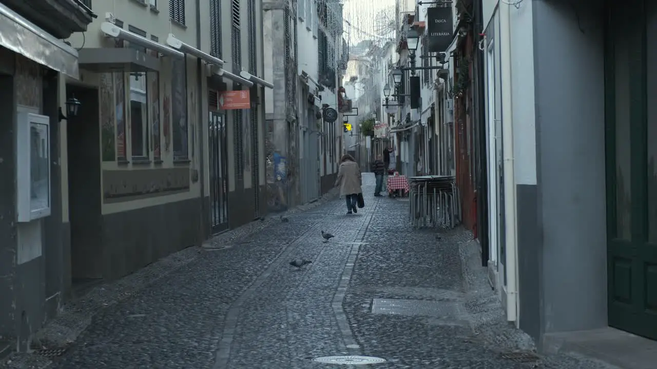 Still shot Funchal old town street with woman walking away Madeira Island