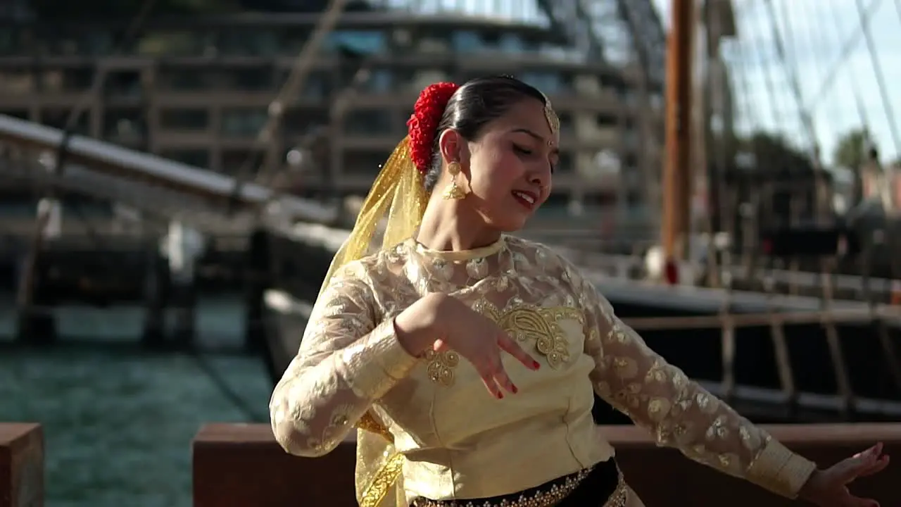 Woman Performing The Classical Dance Of India In Front Of Sydney Harbour Bridge In Australia medium shot