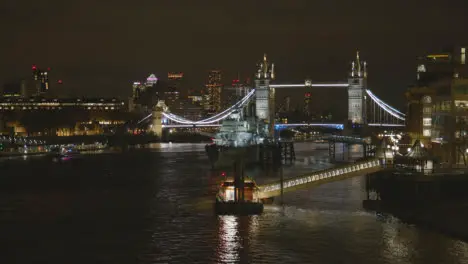 Tower Bridge And City Skyline With HMS Belfast On River Thames London UK At Night