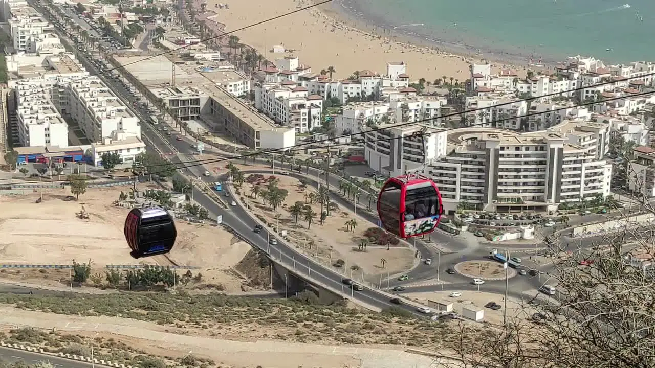 Cable car of the aerial tramway connecting Oufella peak and Agadir city in Morocco overlooking a panoramic view of the beach