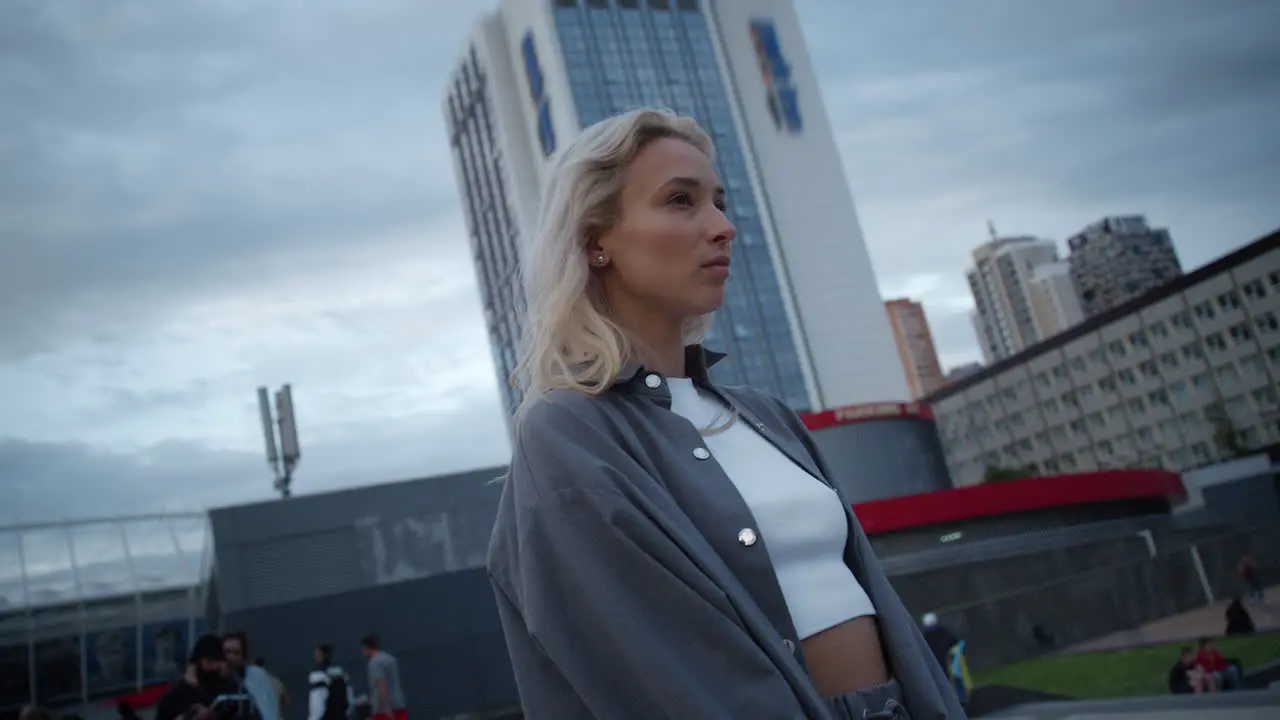 Beautiful girl looking view of cityscape at dusk evening in urban area