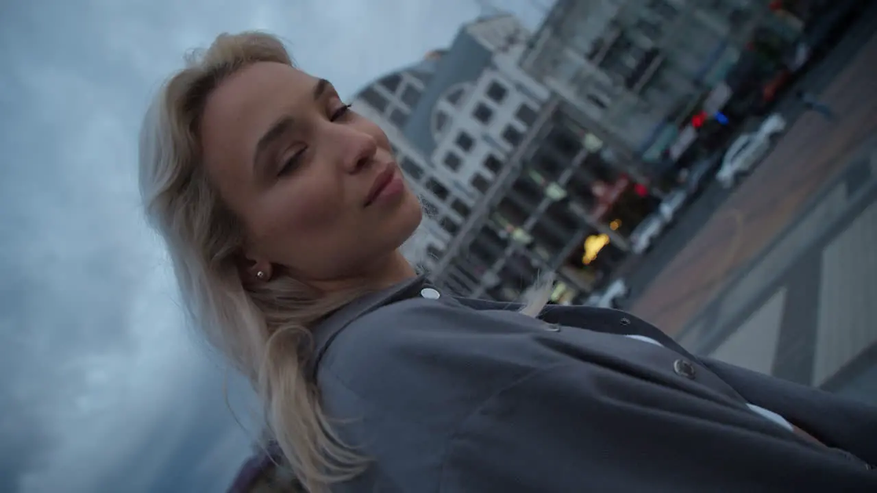 Woman face looking city at evening town in urban background