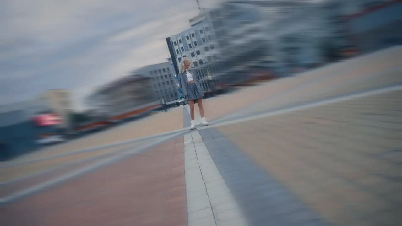 City girl posing camera at evening town street lights in urban area