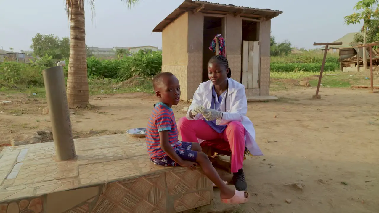 Women doctor vaccinating a young child and protecting against malaria