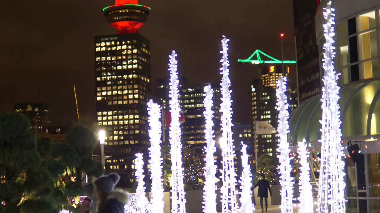 Girl posing infront of Illuminated city decoration in downton Vancouver