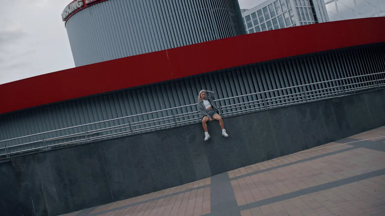 Female model posing urban fashion on modern city street building