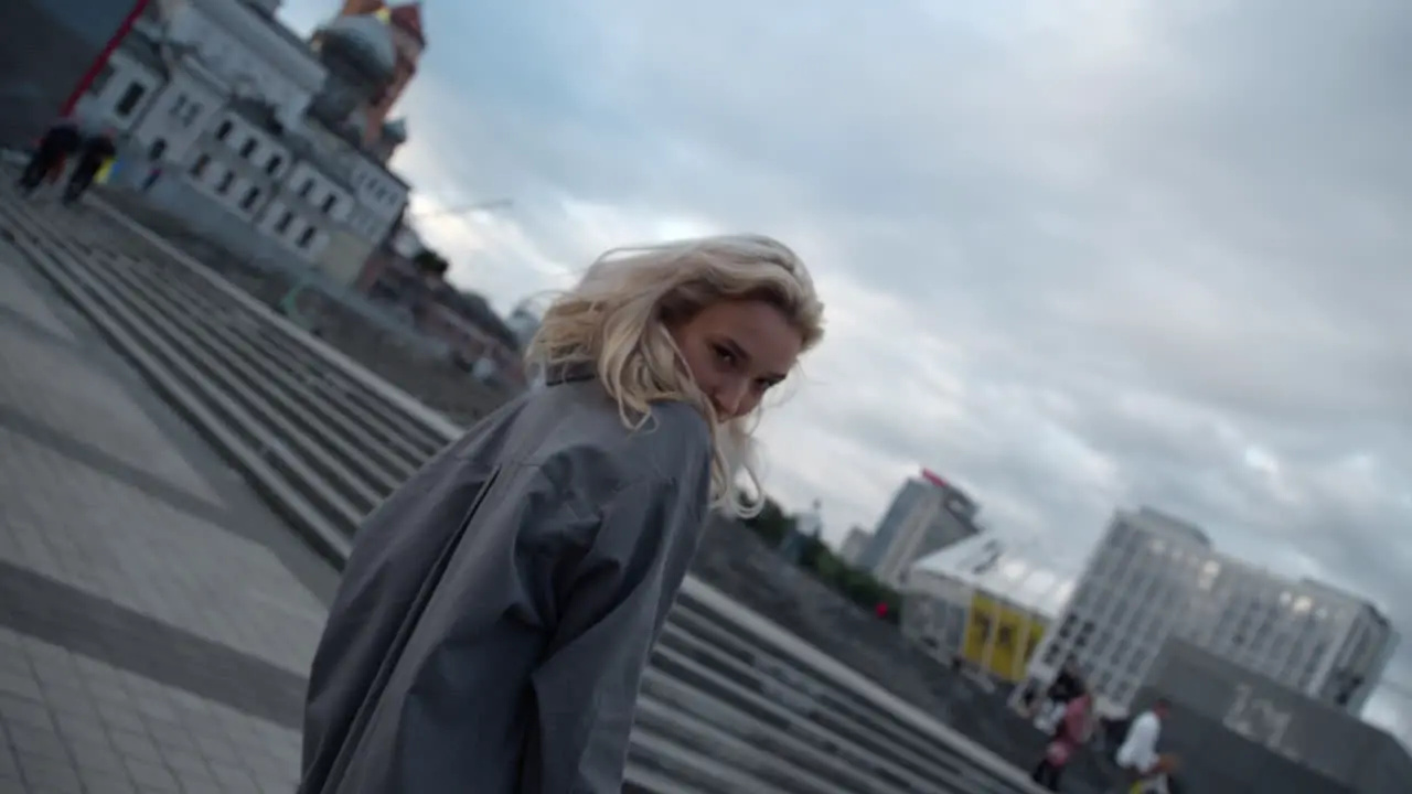 Beautiful model posing city with blonde hair in urban buildings