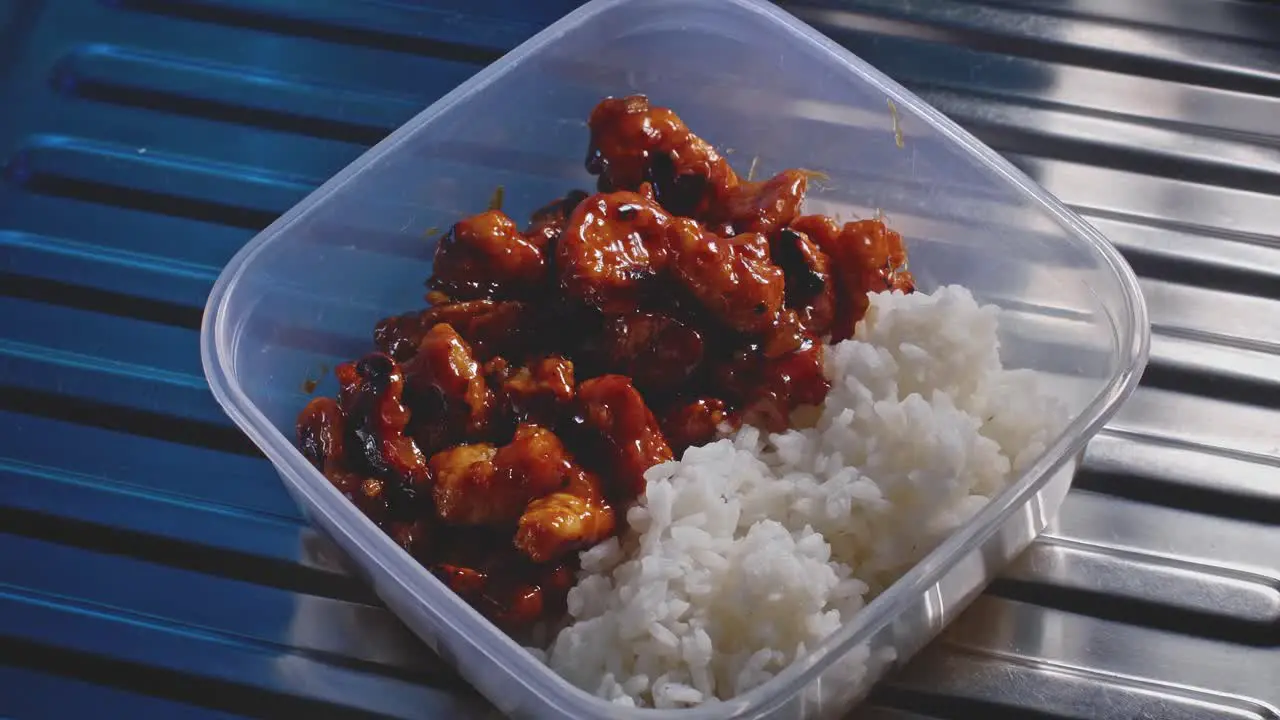 Sweet and sour chicken with rice getting into focus healthy homemade food in a tupper