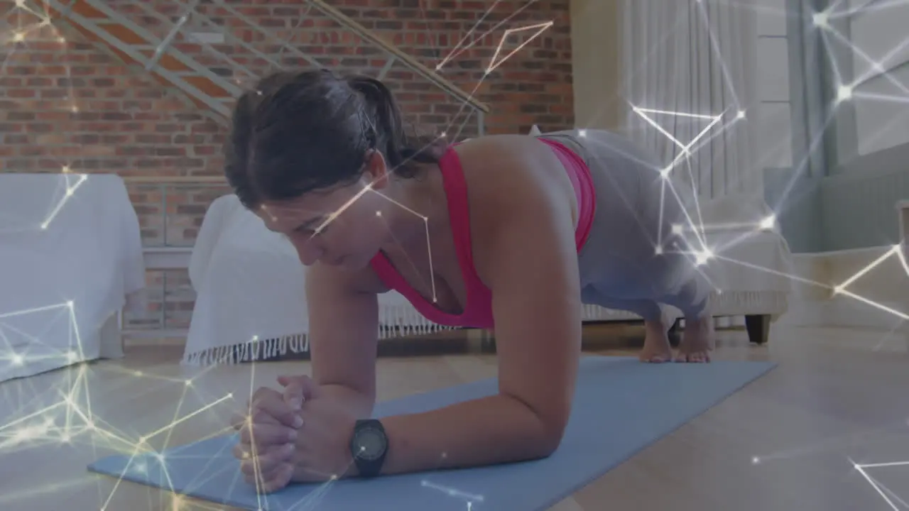 Glowing network of connections against caucasian woman performing plank exercise at home