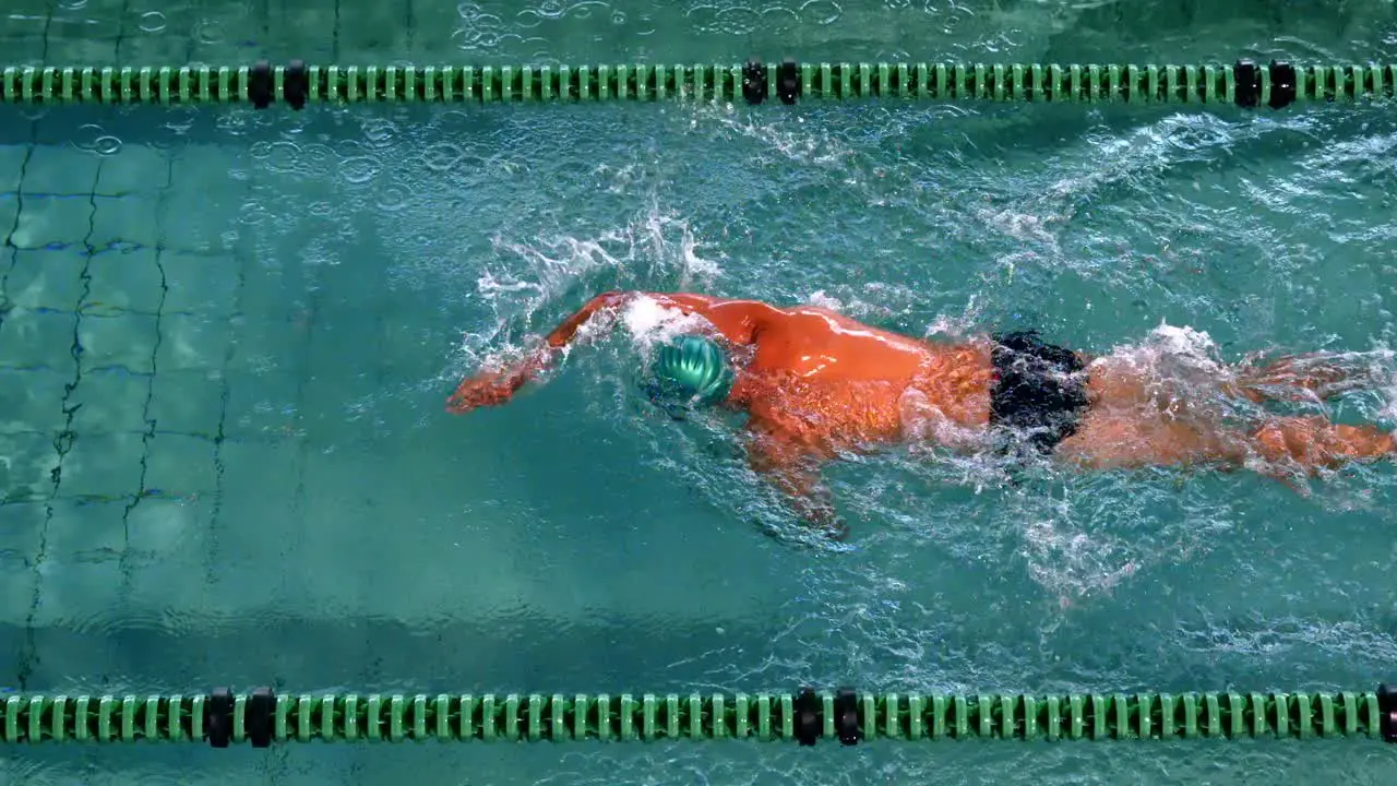 Fit swimmer doing the front stroke in the swimming pool