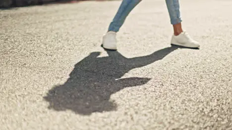 Feet dancing and woman in city street