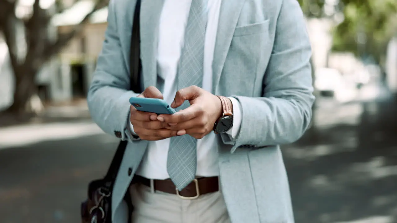 Business man hands with phone in city street