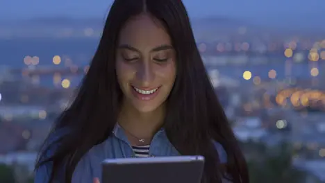 Woman digital tablet and city background at night