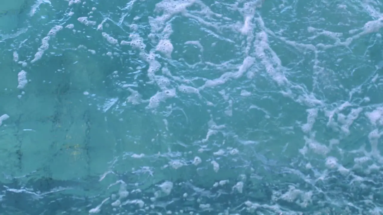 Fit woman doing front stroke in swimming pool