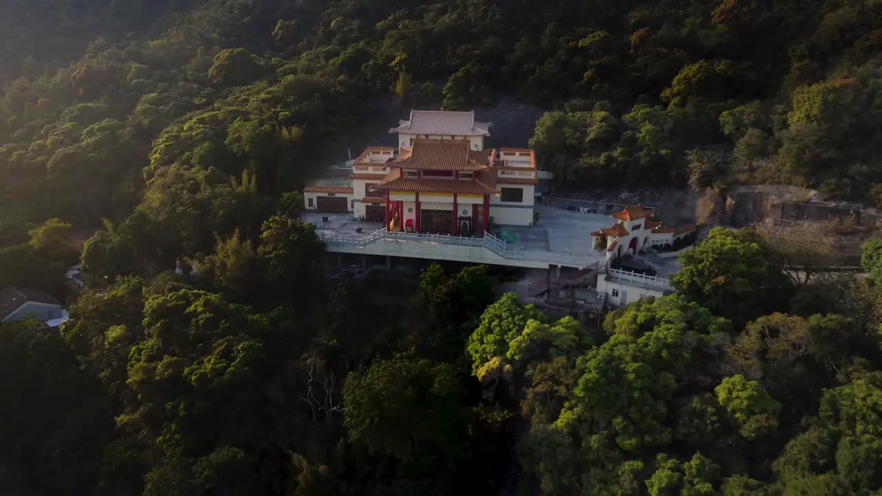 Backwards Drone Shot of a Golden Temple in Hong Kong