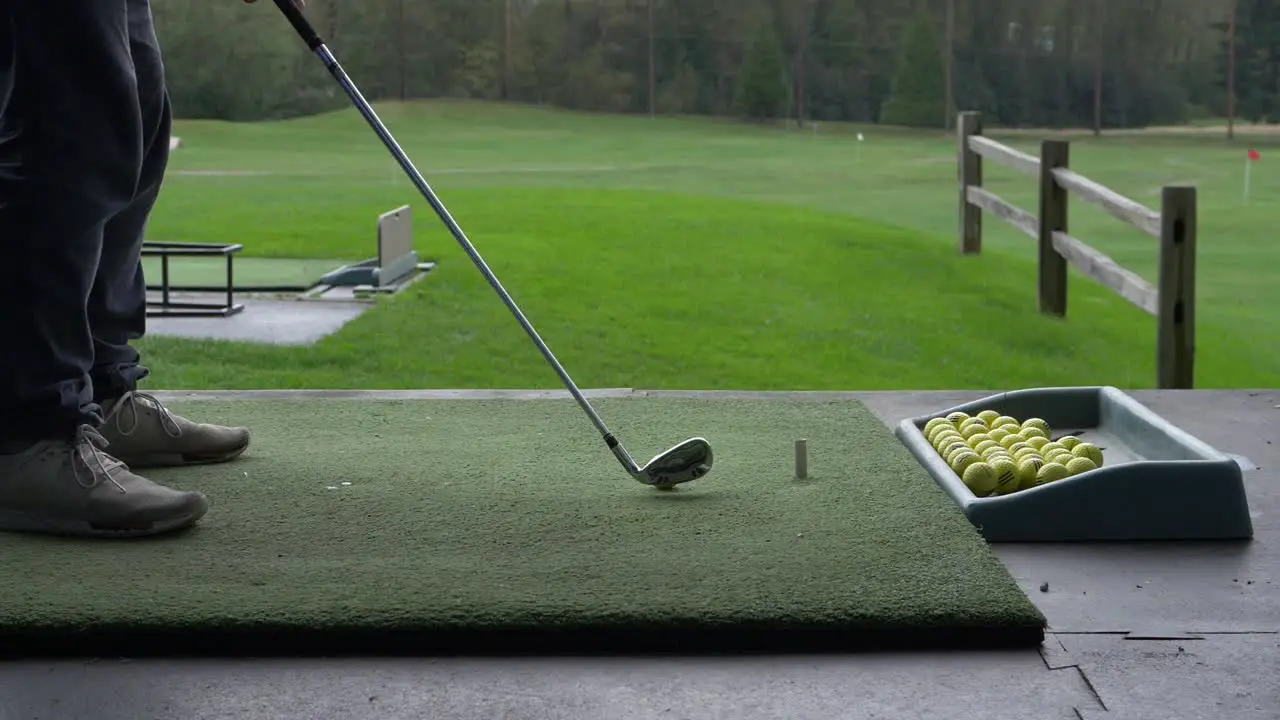 hitting the ball using an iron at the driving range