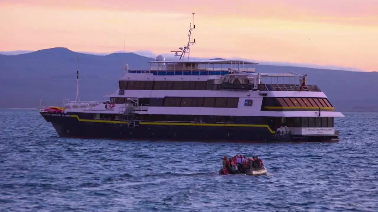 Tourists return to a research boat in the Galapagos Islands