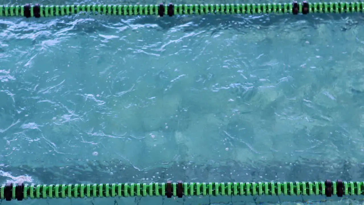 Fit swimmer doing the breast stroke in the swimming pool