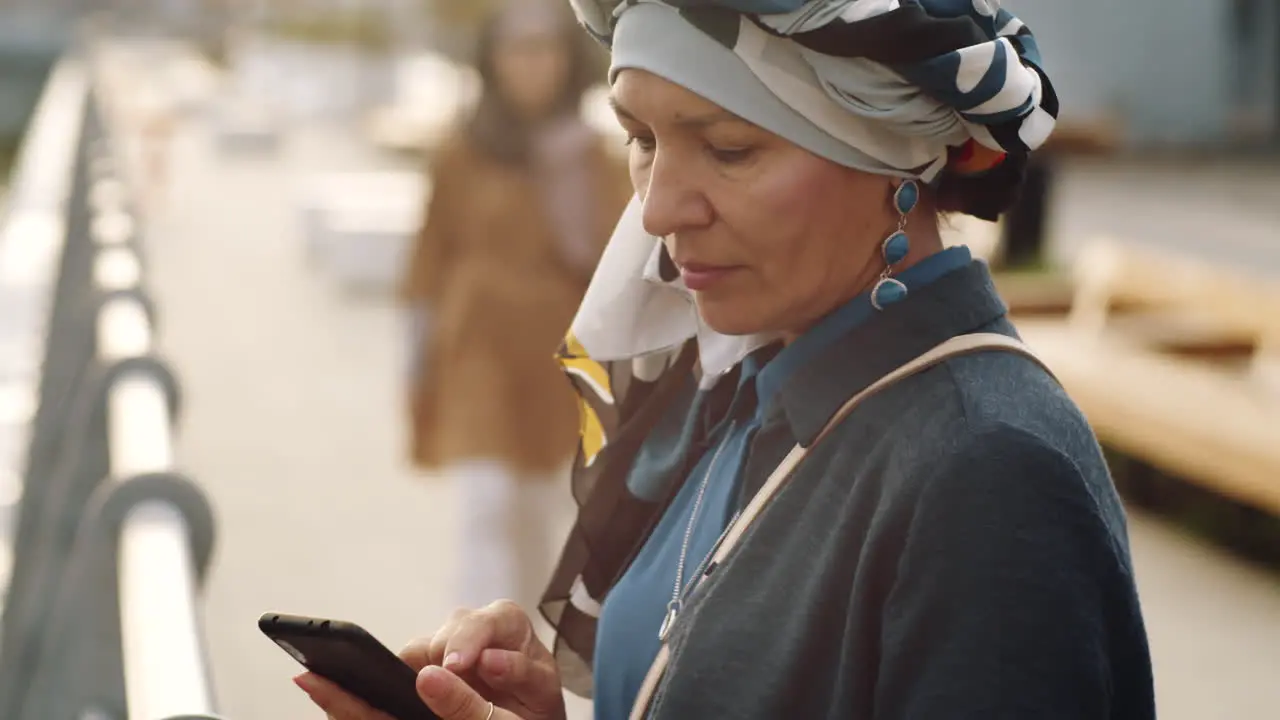 Mature Woman Using Smartphone Outdoors