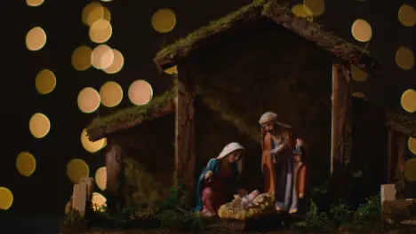 Studio Christmas Scene With Figures Of Mary Joseph And Baby Jesus In Manger From Nativity With Lights