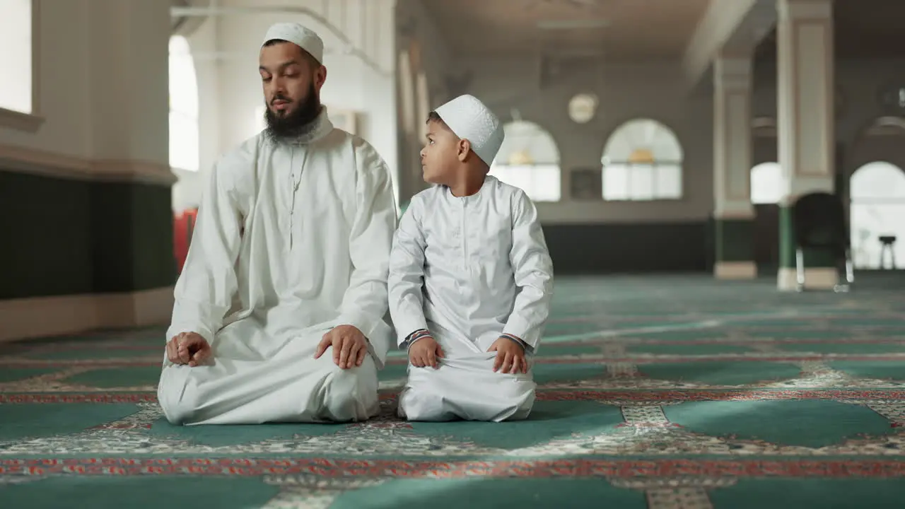 Muslim praying and father with child in Mosque