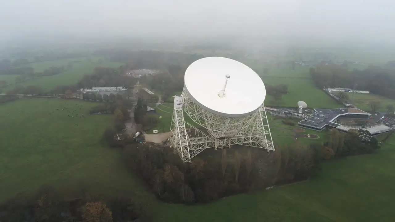 Aerial Jodrell bank observatory Lovell telescope misty rural countryside high orbit right