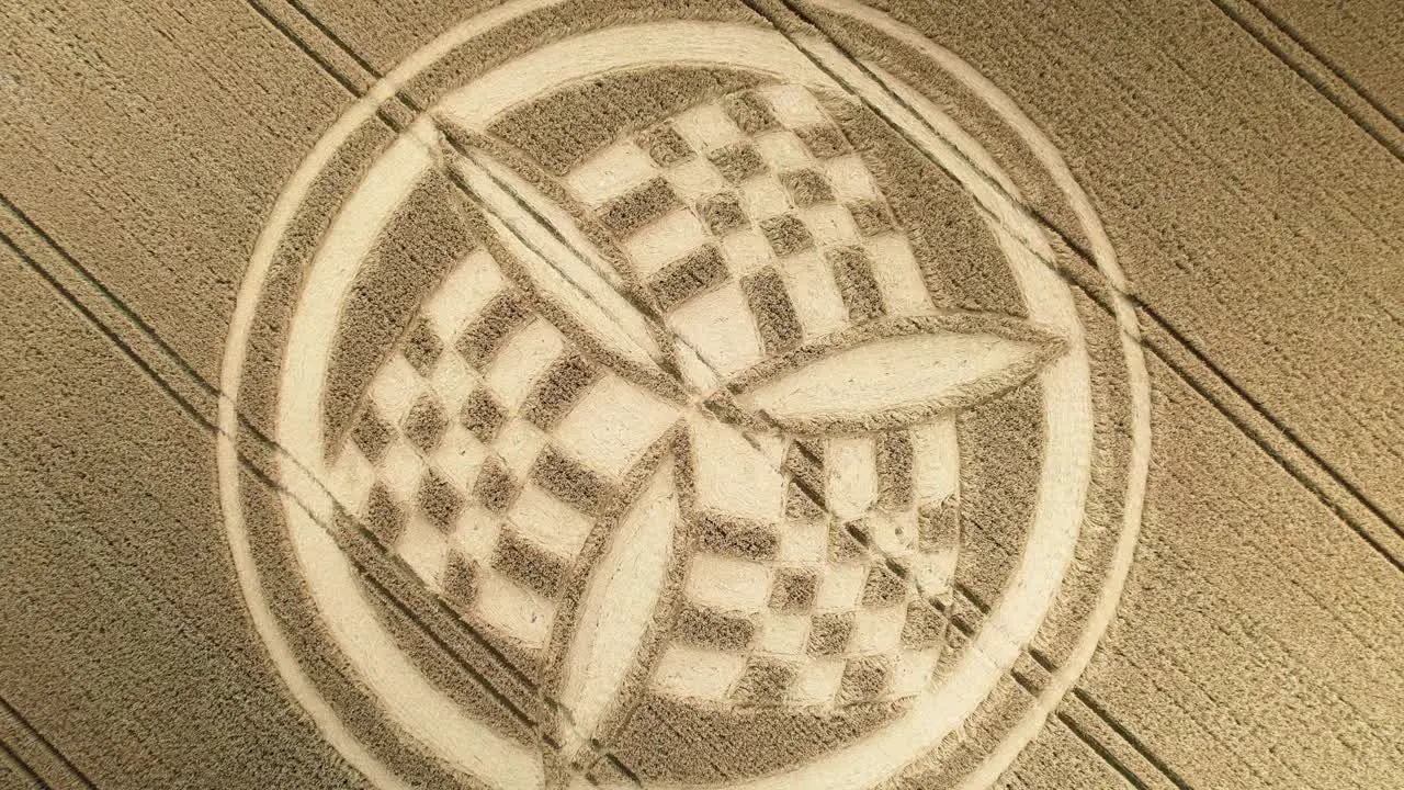 Aerial view rising over golden Hampshire unique trinity crop circle wheat field in South Wonston 2023