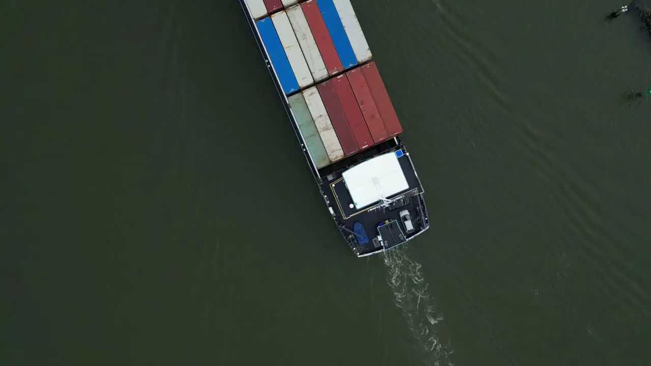 Aerial Top Down View Of Stacked Cargo Containers Being Transported On River