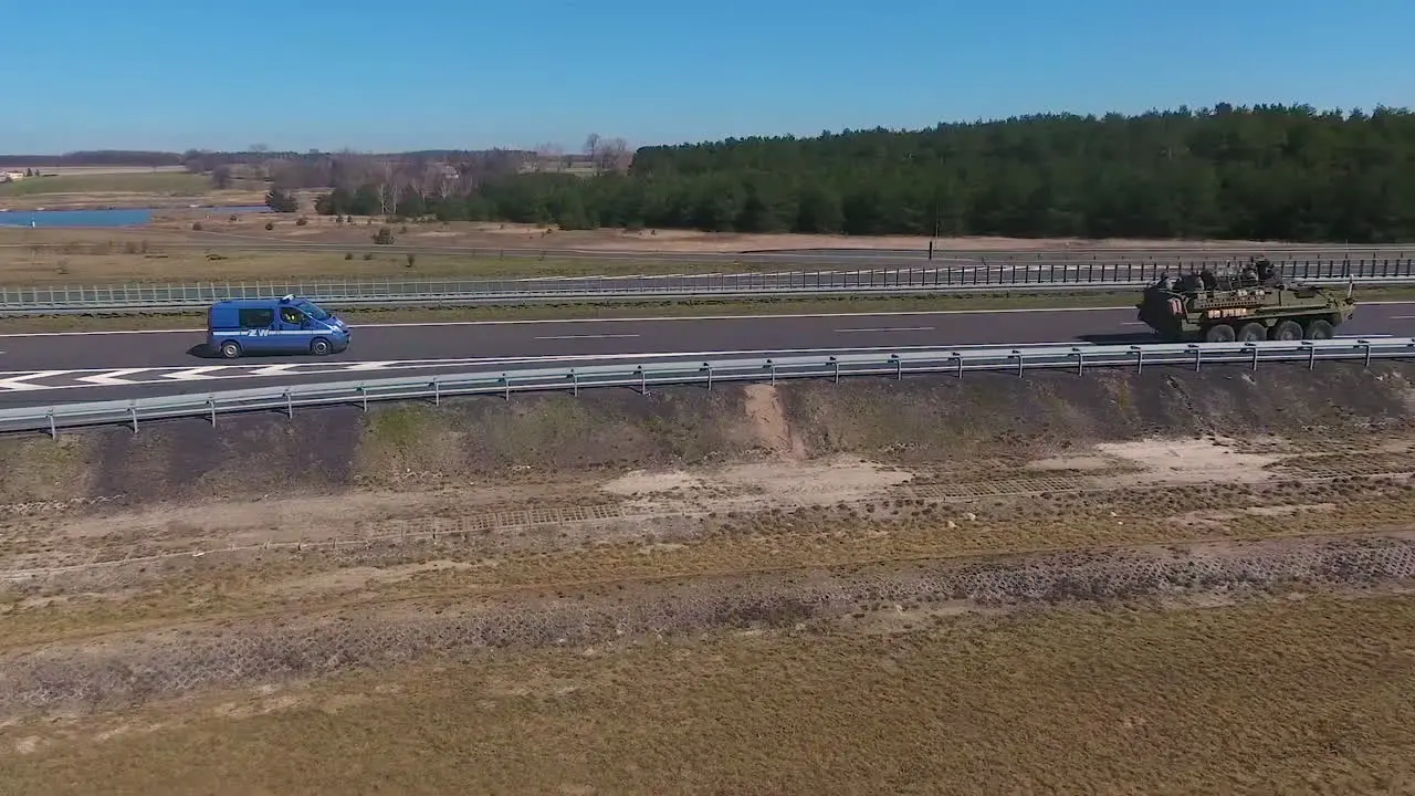 A Nato Convoy Led By American Tanks Moves Along A European Highway