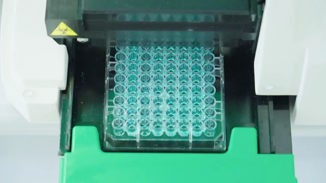 Close Up Of Scientific Equipment Machine Filling Microplate In Laboratory 4K