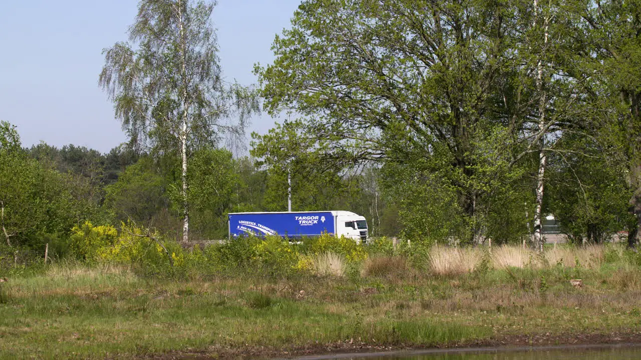 traffic on a busy highway next to a nature reserve is a stark contrast