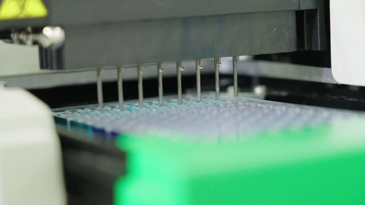 Automated Machine Filling Micro Plate With Liquid In Medical Science Laboratory 4K Close Up