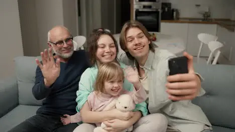 Grandfather and grandchildren are having fun to make selfie or video call to family with smartphone