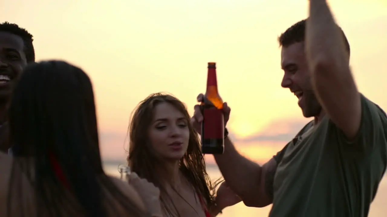 Group Of Friends Having Fun And Dancing In A Party At Sunset