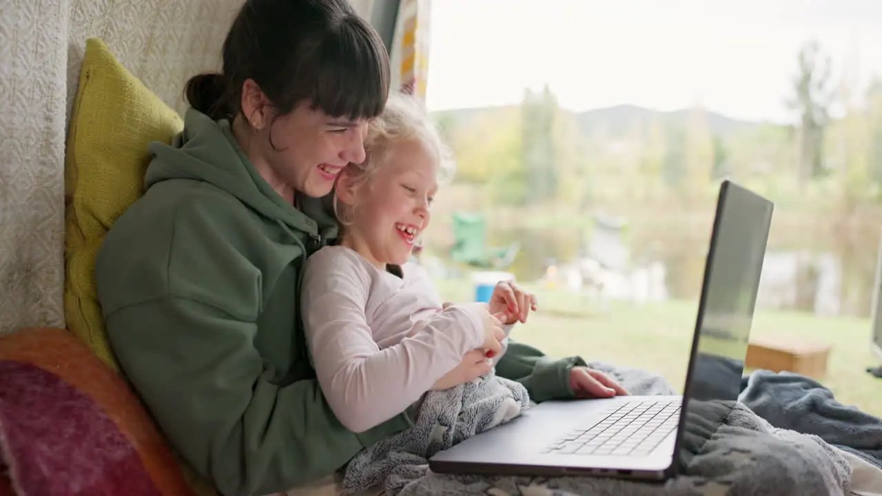 Laptop happy and mother with child in bed