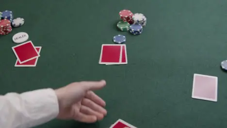 Over the Shoulder Shot of a Poker Dealer Dealing Cards 