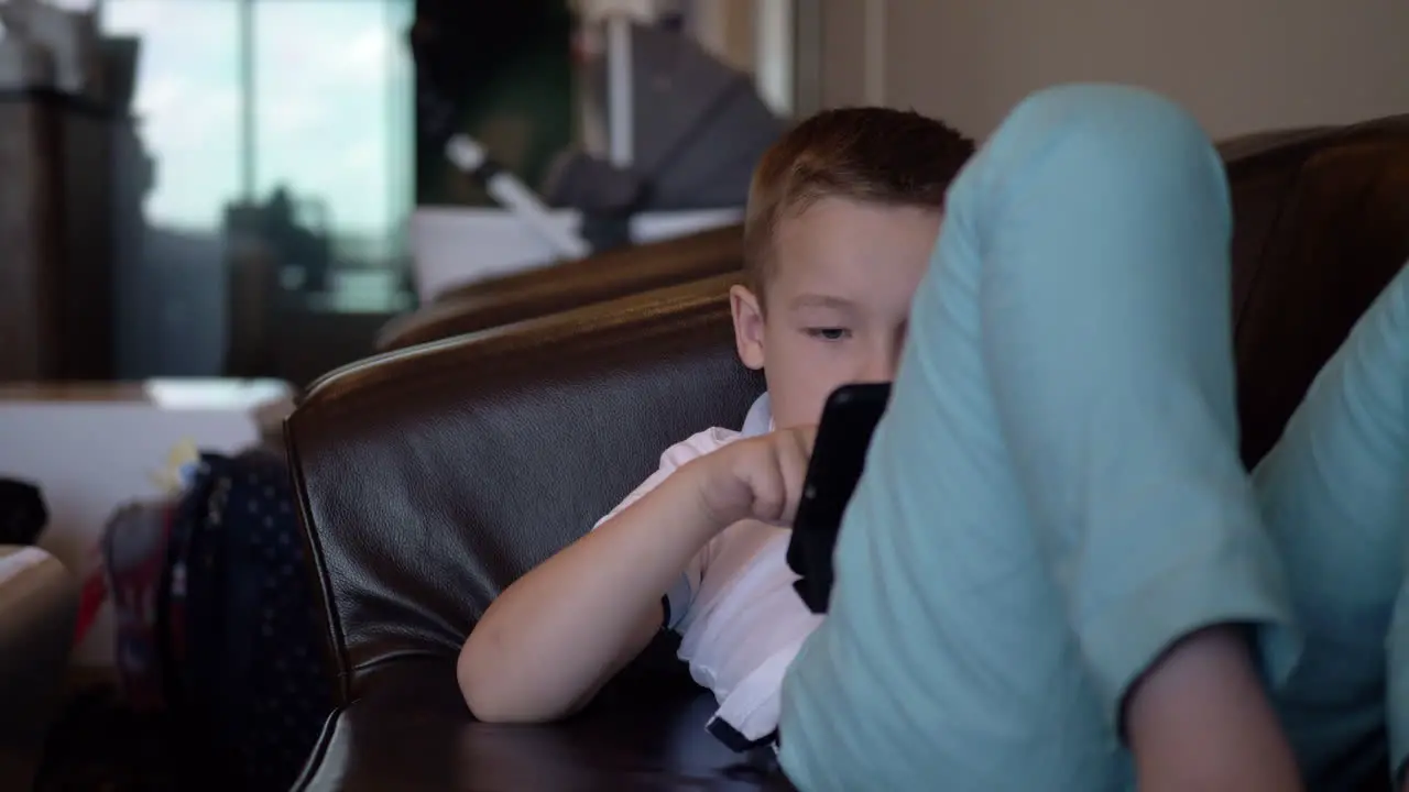 Kid with digital tablet relaxing in airport lounge