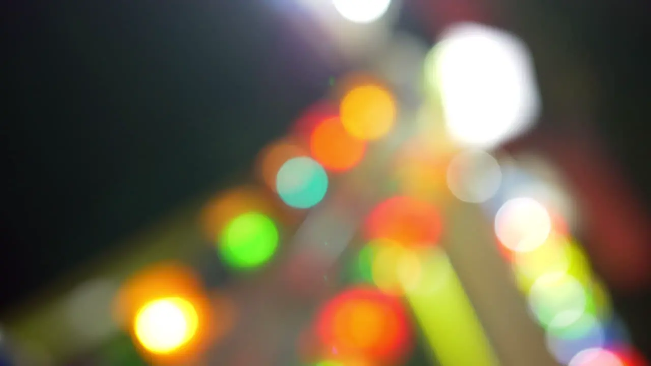 Colorful illumination of attraction at fun fair defocus