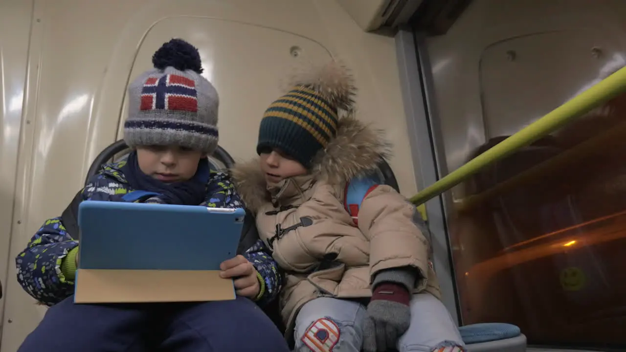 Children playing touch pad games on the bus