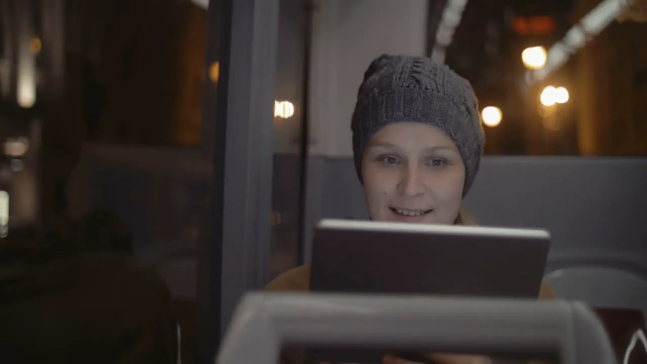 Woman in the bus using tablet computer