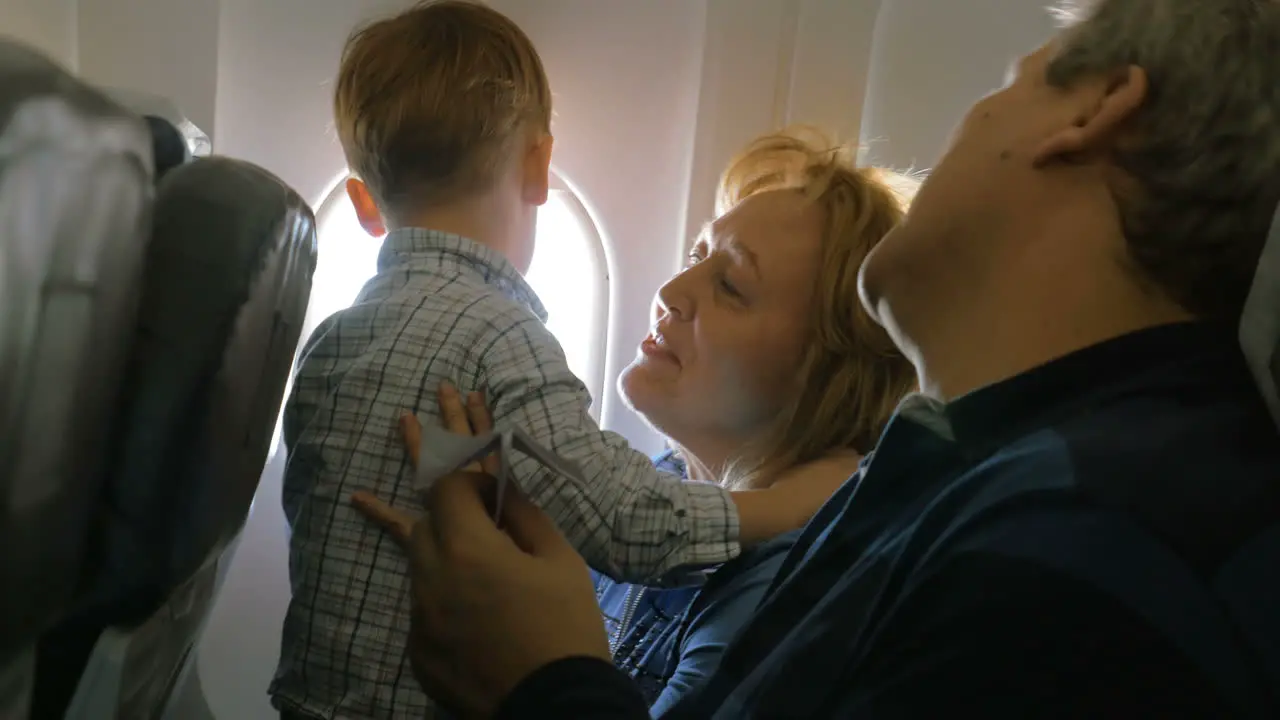 Grandparents and little grandson traveling by plane