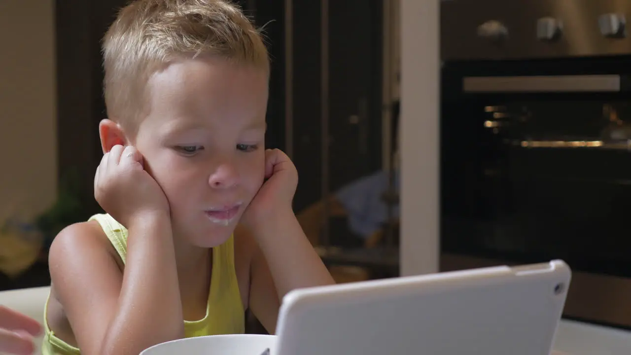 Child having meal with cartoons on pad