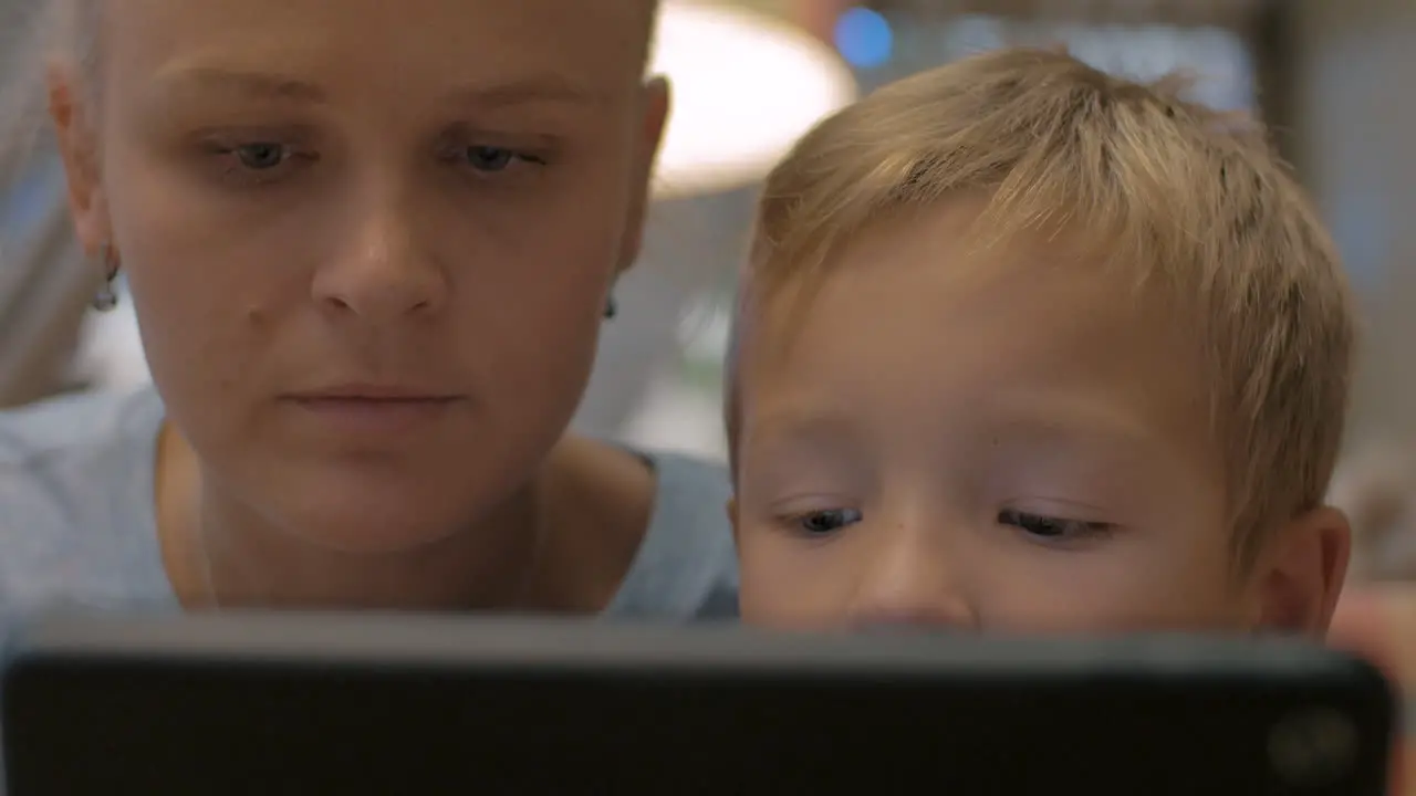 Mother and child spending time on touch pad using