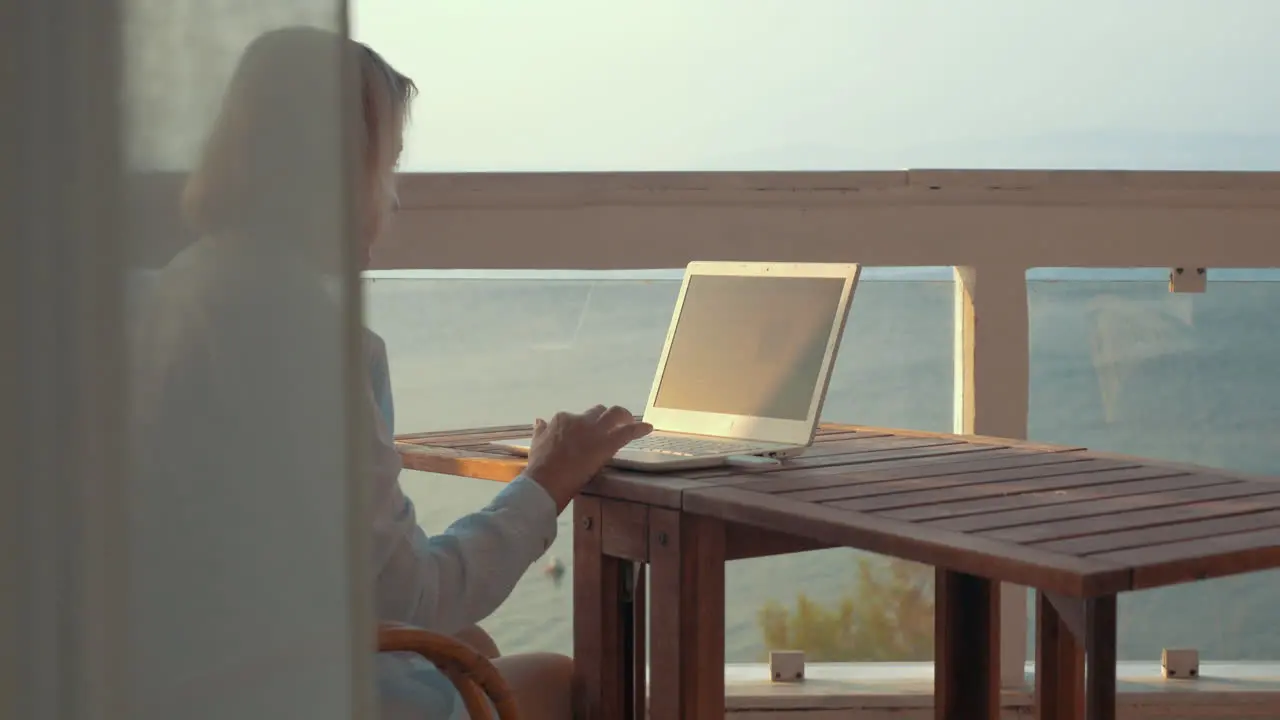 Woman browsing on laptop using mobile internet